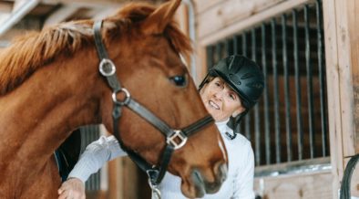 woman grooming a horse