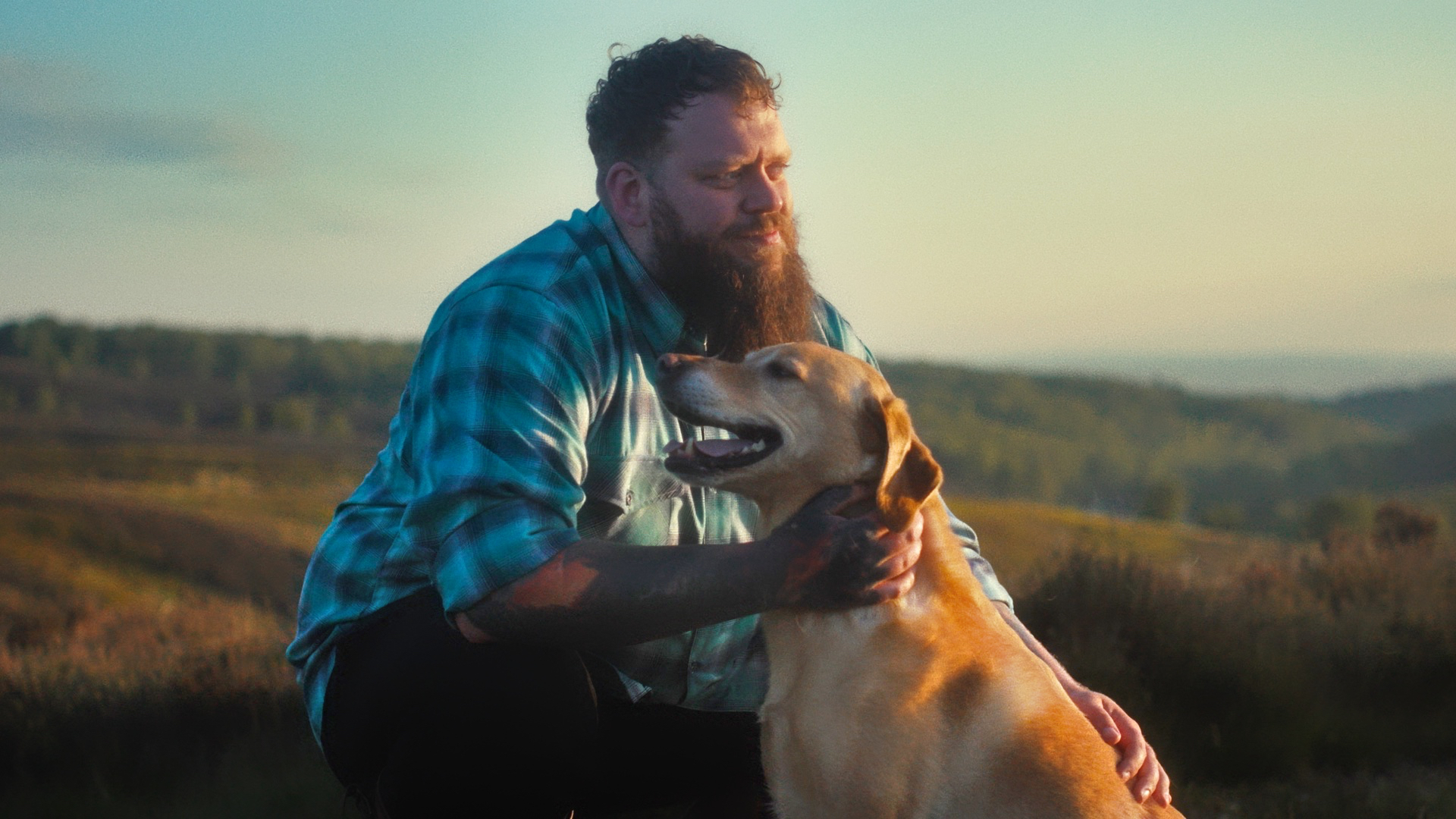 man hugging dog